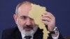 Armenia - Prime Minister Nikol Pashinian holds a cardboard cutout of Armenia's map at a news conference in Yerevan, March 12, 2024,