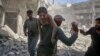 SYRIA -- A man evacuates a young bombing casualty after a reported air strike by regime forces and their allies in the jihadist-held Syrian town of Maaret Al-Noman in the southern Idlib province, on May 26, 2019.