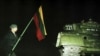 LITHUANIA -- A man holding Lithuanian flag stands near a Soviet tank in Vilnius, January 13, 1991