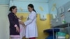 Kyrgyzstan -- a maternity nurse Sahida Kydyraliyeva and a pregnant woman in a clinic on May 2, 2018