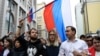 RUSSIA -- Candidates to the Moscow City Duma Lyubov Sobol (C) and Ivan Zhdanov (R) attend a rally against efforts to stop opposition candidates to register for elections to the Moscow City Duma in central Moscow, July 14, 2019