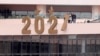 Cairo's Tahrir Square, Egypt - People, wearing protective face masks amid the coronavirus disease (COVID-19) pandemic, arrange decorations for New Year 2021